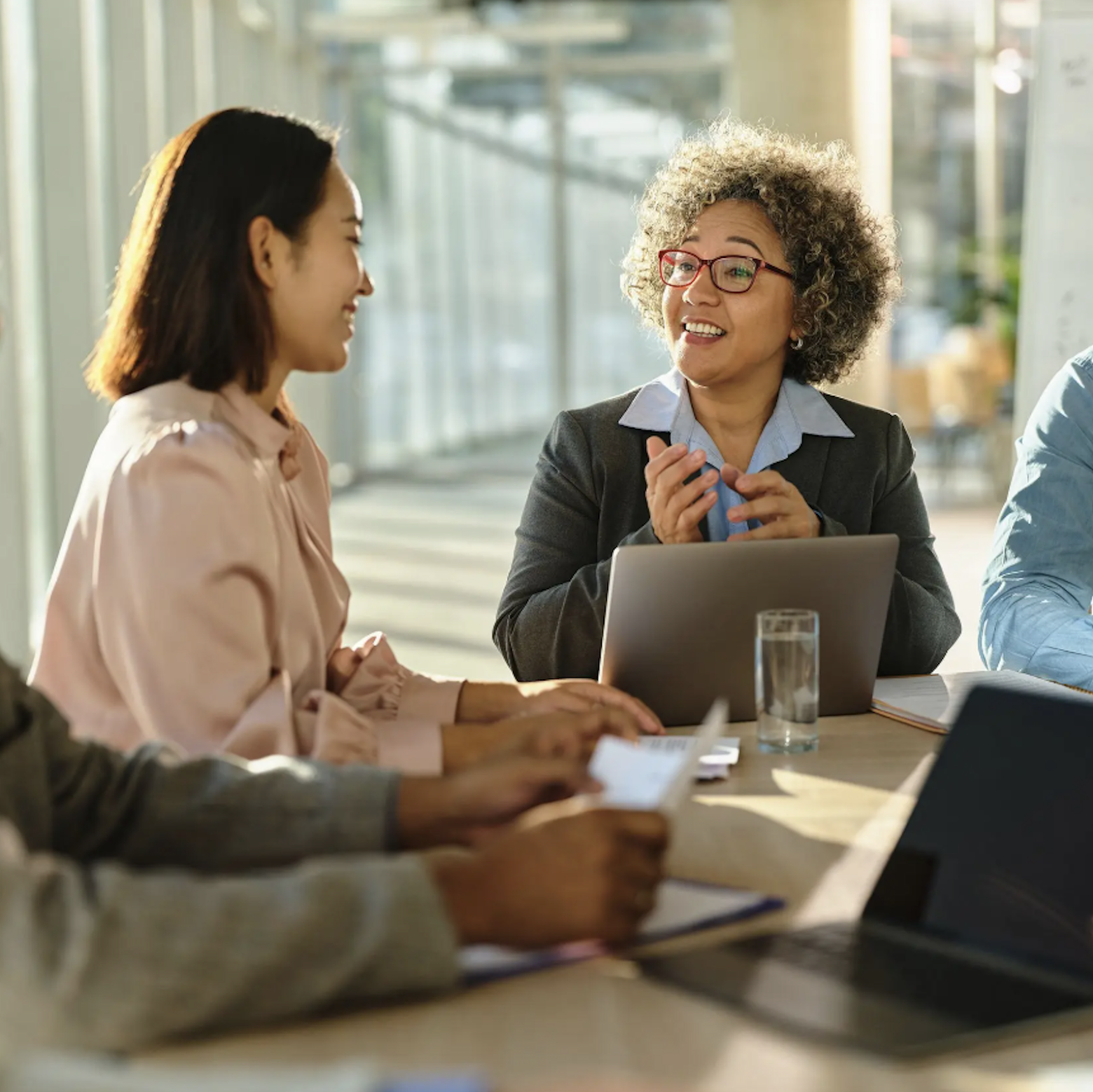 business-group-talking-table-laptops_tall